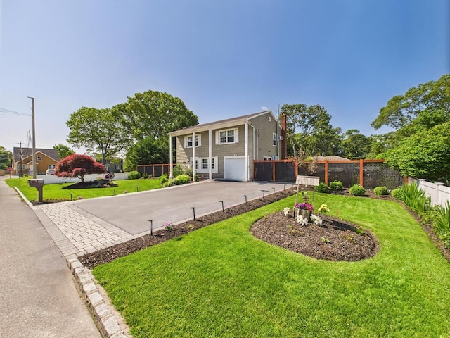 12 Turin St, East Patchogue, NY 11772 - view of front of house with a garage, driveway, and a chimney