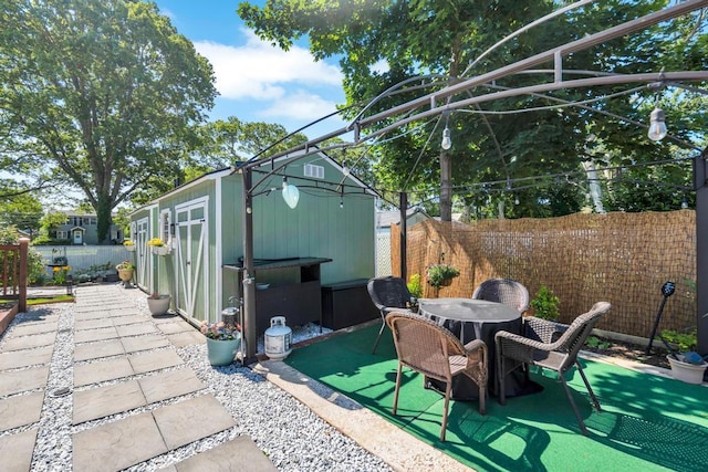 12 Turin St, East Patchogue, NY 11772 - fenced backyard with a patio, an outbuilding, and outdoor dining space
