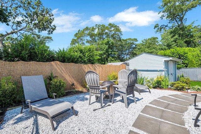 12 Turin St, East Patchogue, NY 11772 - fenced backyard featuring a patio and a storage shed