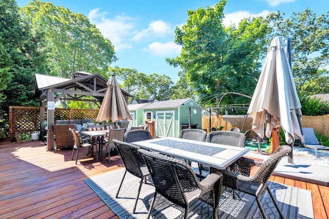 12 Turin St, East Patchogue, NY 11772 - wooden terrace with outdoor dining area, a shed, a fenced backyard, and a gazebo