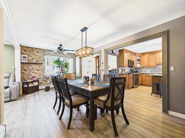 12 Turin St, East Patchogue, NY 11772 - dining space with light wood-type flooring, a ceiling fan, a chandelier, and ornamental molding