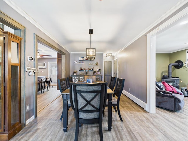 12 Turin St, East Patchogue, NY 11772 - dining area with a wood stove, wood finished floors, ornamental molding, a wall mounted air conditioner, and a baseboard heating unit