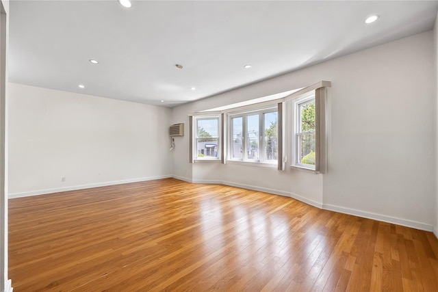 50-55 Cloverdale Blvd, Bayside, NY 11364 - empty room with light wood-style floors, recessed lighting, and a wall mounted air conditioner