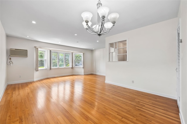 50-55 Cloverdale Blvd, Bayside, NY 11364 - unfurnished room featuring a chandelier, light wood-type flooring, an AC wall unit, and recessed lighting