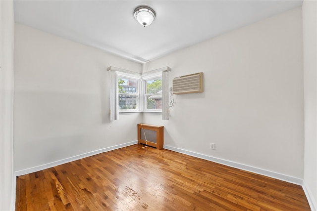50-55 Cloverdale Blvd, Bayside, NY 11364 - spare room with a wall mounted AC and wood-type flooring