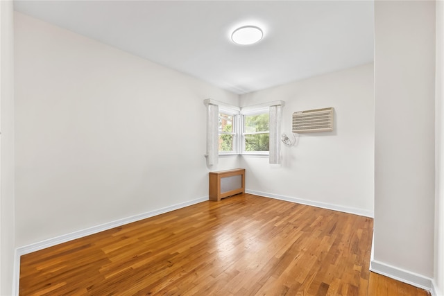 50-55 Cloverdale Blvd, Bayside, NY 11364 - unfurnished room with a wall mounted air conditioner and light wood finished floors
