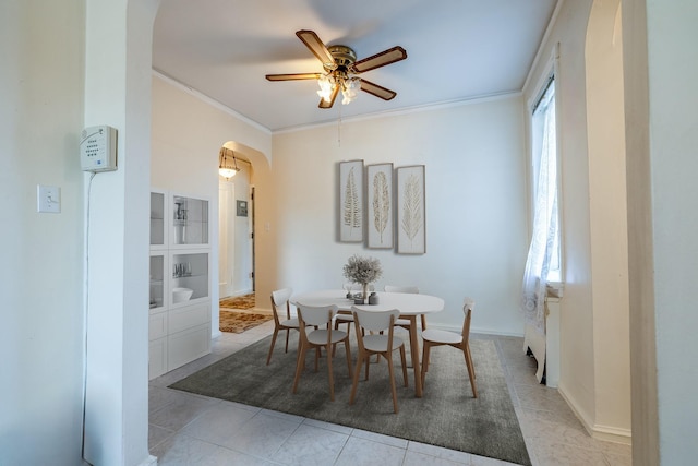 251 Seaman Ave Unit 6A, New York Manhattan, NY 10034 - tiled dining room featuring arched walkways, ceiling fan, and crown molding