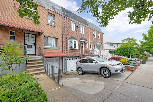 66-48 73rd Pl, Middle Village, NY 11379 - townhome / multi-family property featuring driveway, an attached garage, a shingled roof, and brick siding