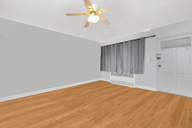 66-48 73rd Pl, Middle Village, NY 11379 - unfurnished room with radiator heating unit, a ceiling fan, and light wood finished floors