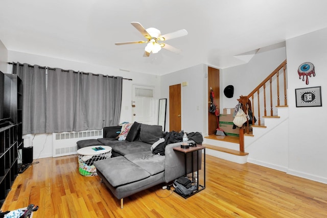 66-48 73rd Pl, Middle Village, NY 11379 - living area with radiator, stairs, wood finished floors, and ceiling fan
