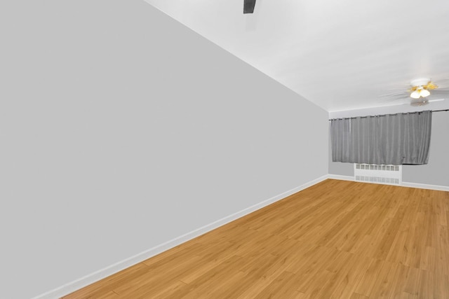 66-48 73rd Pl, Middle Village, NY 11379 - spare room with a ceiling fan, radiator heating unit, and light wood-style flooring