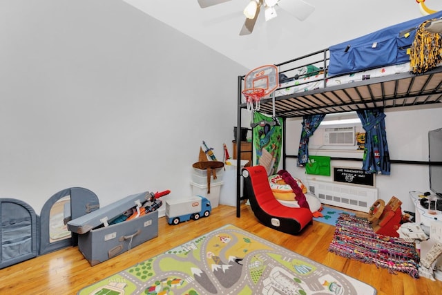 66-48 73rd Pl, Middle Village, NY 11379 - bedroom with cooling unit, wood finished floors, and radiator heating unit
