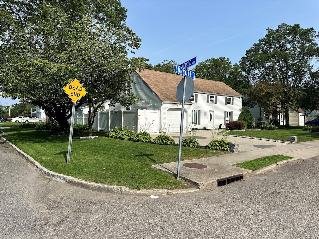 7 Lurcott Ln, Central Islip, NY 11722 - view of front of house with an attached garage and concrete driveway