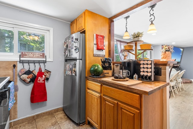 883 Saint James Pl, Franklin Square, NY 11010 - kitchen featuring freestanding refrigerator, stove, brown cabinetry, hanging light fixtures, and wooden counters