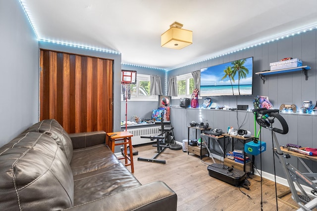 883 Saint James Pl, Franklin Square, NY 11010 - exercise area with wood finished floors and radiator heating unit
