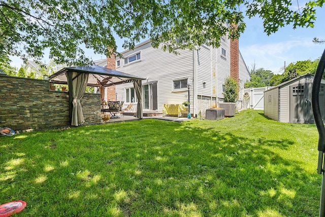 883 Saint James Pl, Franklin Square, NY 11010 - rear view of property featuring a patio area, a shed, a gazebo, a fenced backyard, and a chimney