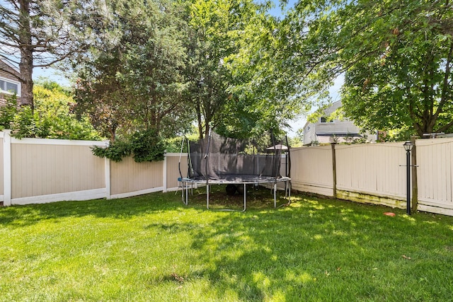 883 Saint James Pl, Franklin Square, NY 11010 - fenced backyard with a trampoline