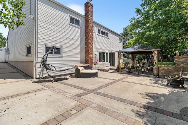 883 Saint James Pl, Franklin Square, NY 11010 - rear view of house featuring a gazebo, an outdoor hangout area, a patio area, and a chimney
