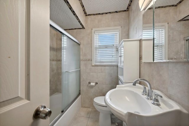 5 Charles St, Valley Stream, NY 11580 - full bath featuring tile walls, tile patterned floors, and combined bath / shower with glass door