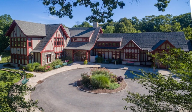 221 Schrade Unit 2G, Briarcliff Manor, NY 10510 - tudor house with a chimney and stone siding