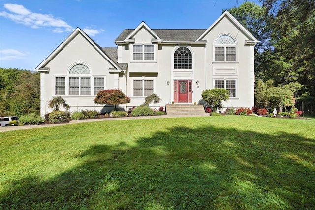 48 Brennan Ct, Chester, NY 10918 - view of front facade featuring a front lawn and stucco siding