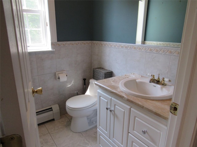 48 Brennan Ct, Chester, NY 10918 - bathroom featuring a baseboard radiator, tile walls, vanity, tile patterned flooring, and wainscoting