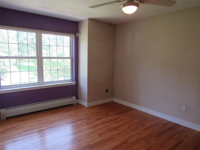 48 Brennan Ct, Chester, NY 10918 - unfurnished room featuring a baseboard heating unit, a ceiling fan, and wood finished floors