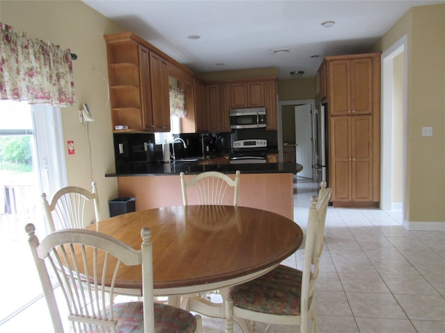 48 Brennan Ct, Chester, NY 10918 - kitchen with stainless steel microwave, range with electric cooktop, open shelves, a peninsula, and light tile patterned floors