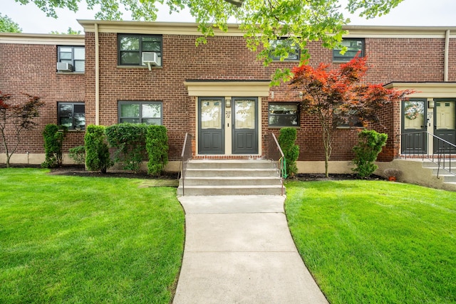 218-12 73rd Ave Unit 401A1, Oakland Gardens, NY 11364 - townhome / multi-family property featuring entry steps, brick siding, and a front yard