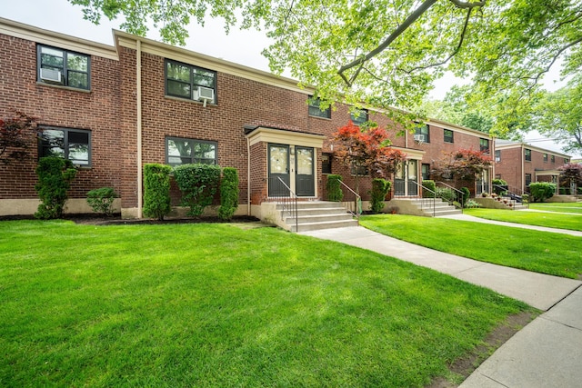 218-12 73rd Ave Unit 401A1, Oakland Gardens, NY 11364 - townhome / multi-family property with a front lawn and brick siding