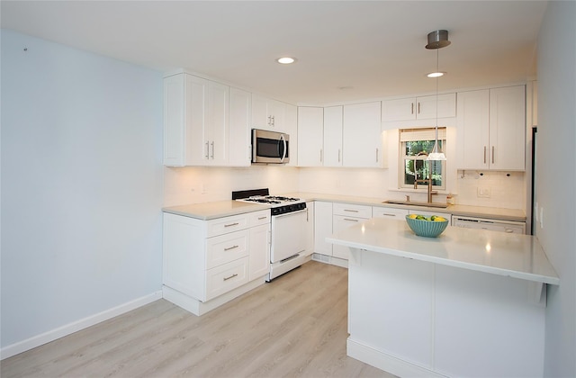 1565 Rte 292, Holmes, NY 12531 - kitchen with white appliances, light wood finished floors, light countertops, decorative backsplash, and recessed lighting