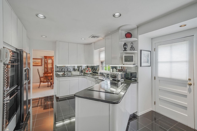 30 Twixt Hills Rd, Saint James, NY 11780 - kitchen with black appliances, a peninsula, dark countertops, white cabinetry, and modern cabinets