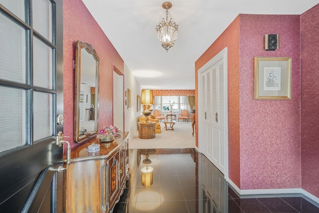 30 Twixt Hills Rd, Saint James, NY 11780 - hallway featuring a chandelier, tile patterned floors, and wallpapered walls