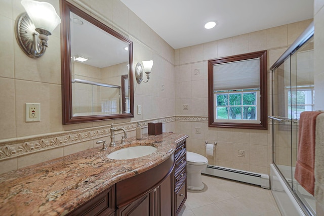 30 Twixt Hills Rd, Saint James, NY 11780 - full bathroom with a baseboard heating unit, tile walls, vanity, tile patterned floors, and enclosed tub / shower combo