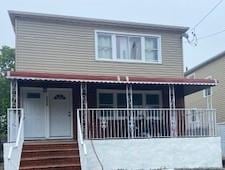 2324 Camp Rd, Far Rockaway, NY 11691 - view of front of property with a porch