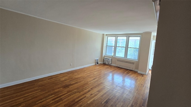 86-05 60th Rd Unit 2E, Elmhurst, NY 11373 - unfurnished room with radiator, wood finished floors, ornamental molding, and a wall unit AC