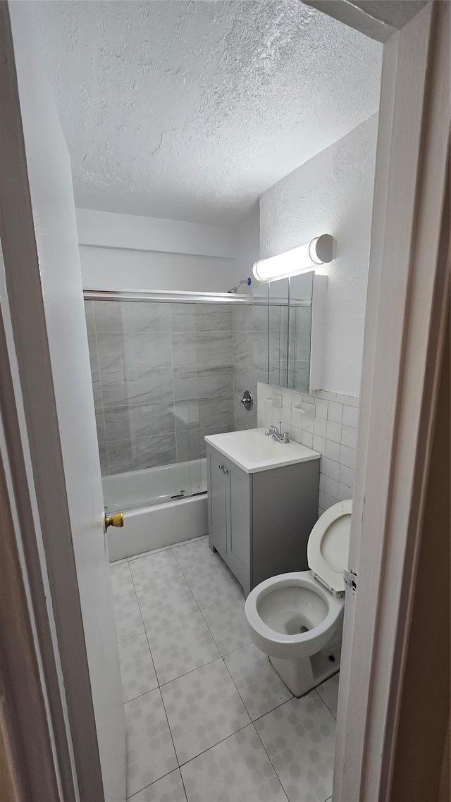 86-05 60th Rd Unit 2E, Elmhurst, NY 11373 - full bathroom featuring bathing tub / shower combination, vanity, tile walls, a textured ceiling, and tile patterned floors