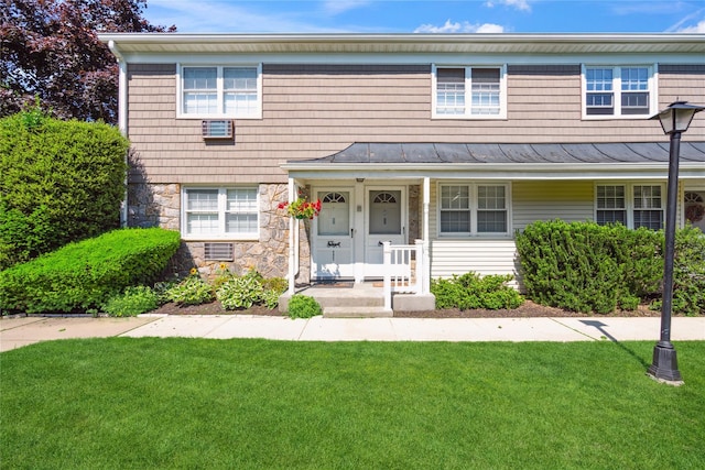 4428 Wilshire Ln Unit J28, Oakdale, NY 11769 - view of front of house with a standing seam roof, a front yard, stone siding, and a metal roof