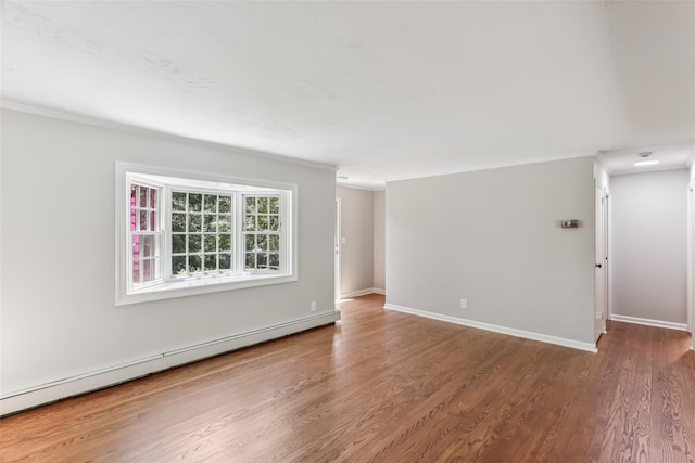 6 Cold Spring Ln, Huntington, NY 11743 - empty room featuring a baseboard heating unit, wood finished floors, and crown molding