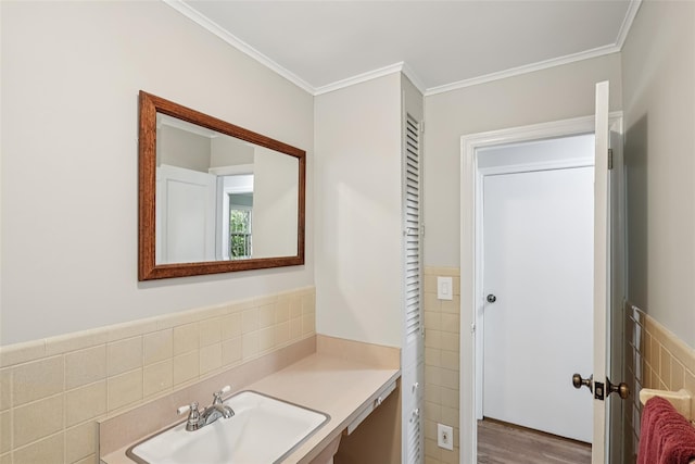 6 Cold Spring Ln, Huntington, NY 11743 - bathroom featuring tile walls, crown molding, vanity, wainscoting, and wood finished floors