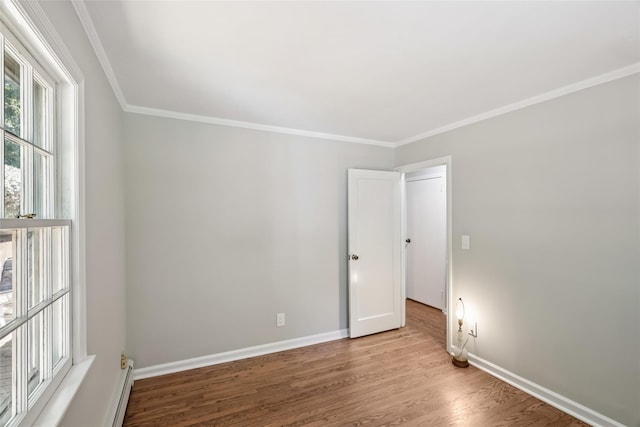 6 Cold Spring Ln, Huntington, NY 11743 - empty room featuring wood finished floors, crown molding, and a baseboard heating unit
