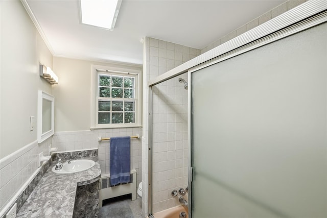 6 Cold Spring Ln, Huntington, NY 11743 - bathroom featuring tile walls, radiator heating unit, vanity, bath / shower combo with glass door, and crown molding