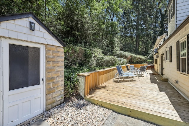 6 Cold Spring Ln, Huntington, NY 11743 - wooden deck with outdoor dining space and view of wooded area
