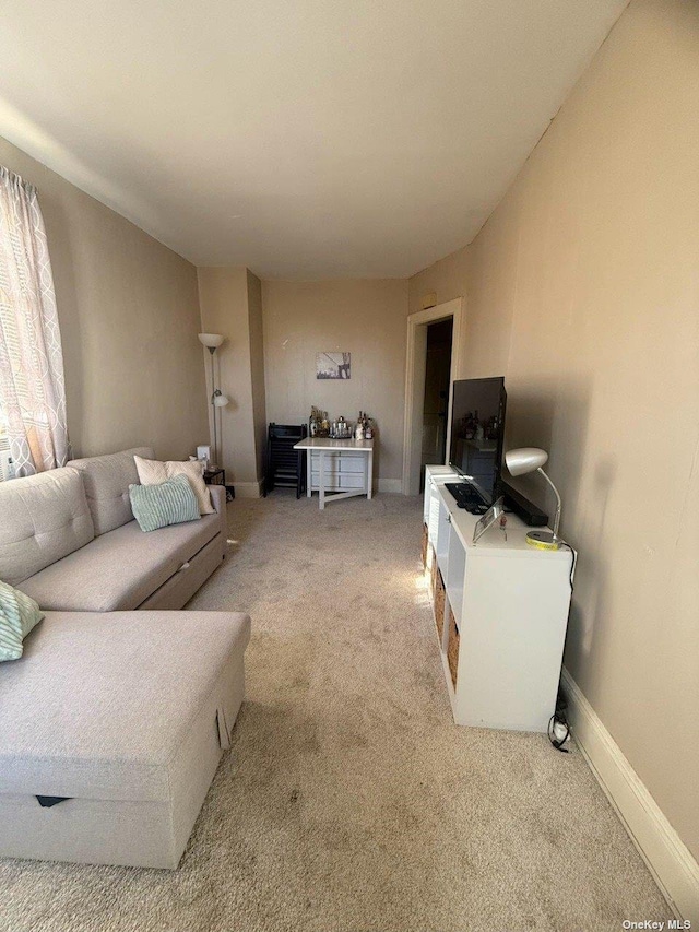 43-67 149th St, Flushing, NY 11355 - carpeted living room featuring baseboards