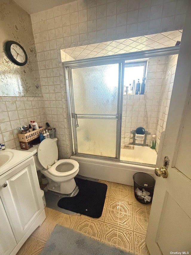 43-67 149th St, Flushing, NY 11355 - bathroom with tile walls, shower / bath combination with glass door, vanity, and tile patterned flooring
