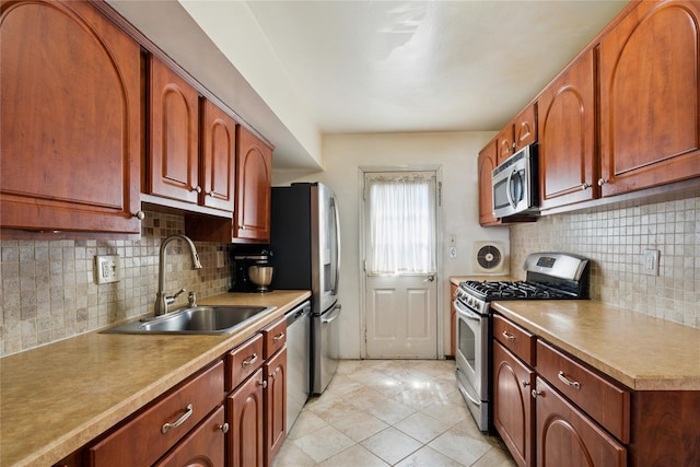 88 E Valley Stream Blvd Unit 7, Valley Stream, NY 11580 - kitchen featuring appliances with stainless steel finishes, backsplash, light tile patterned floors, and light countertops