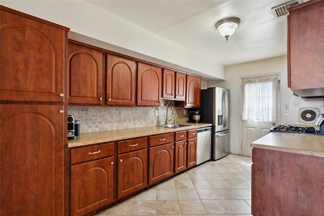 88 E Valley Stream Blvd Unit 7, Valley Stream, NY 11580 - kitchen with stainless steel appliances, backsplash, and light countertops