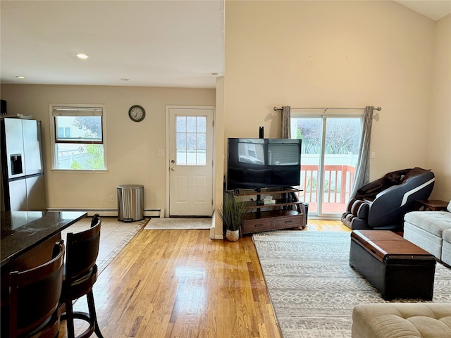 467 Scranton Ave, Lynbrook, NY 11563 - living area with light wood-type flooring, a baseboard heating unit, and recessed lighting