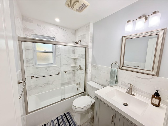 467 Scranton Ave, Lynbrook, NY 11563 - bathroom featuring vanity, combined bath / shower with glass door, and tile walls