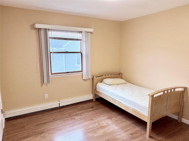 467 Scranton Ave, Lynbrook, NY 11563 - bedroom with a baseboard radiator and wood finished floors